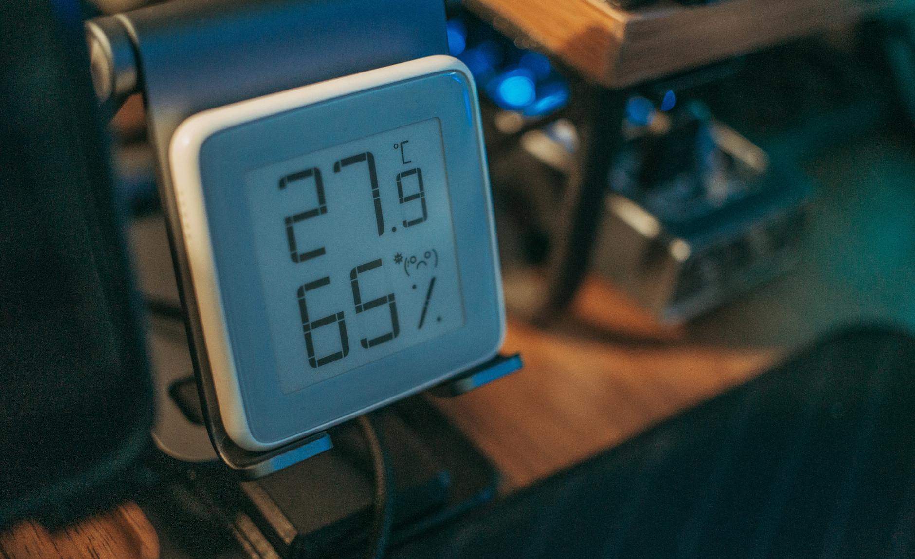 digital hygrometer on desk displaying temperature and humidity